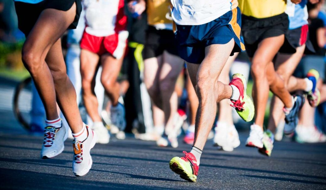 A group of runners running in a marathon event. This blog article explores the common running injuries, and how our physiotherapists approach to assessing and treating them
