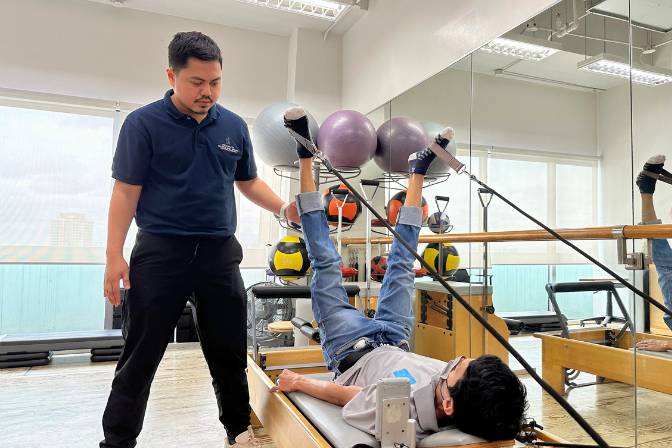 Pilates therapy using a reformer, from Kevin Viloria, a skilled physical therapist at Prohealth Sports and Spinal Physiotherapy Centres in Makati, Manila, Philippines